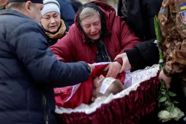 Alla Dimova, mother of Ukranian army officer Vyacheslav Vyacheslavovych Dimov, who was killed on April 16 in battle in Vasylivka district of Zaporizhzhia region, reacts during his funeral, amid Russia's invasion of Ukraine, in the town of Marhanets, in Zaporizhzhia region, Ukraine on April 19, 2022. (Photo by Ueslei Marcelino/Reuters)