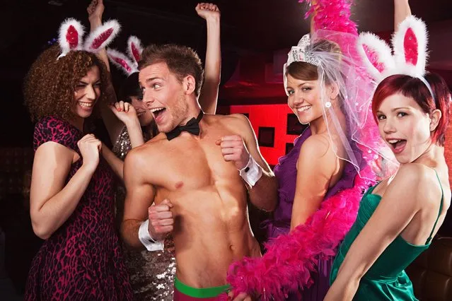 Young women on hen night with male stripper. (Photo by Image Source/Getty Images)