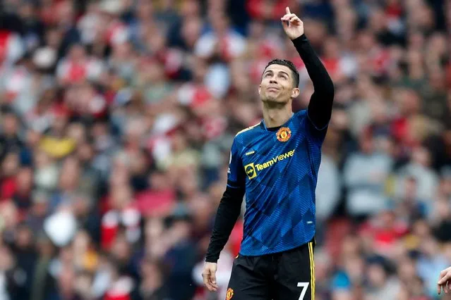 Manchester United's Portuguese striker Cristiano Ronaldo gestures after scoring their first goal during the English Premier League football match between Arsenal and Manchester United at the Emirates Stadium in London on April 23, 2022. (Photo by Ian Kington/IKIMAGES/AFP Photo)