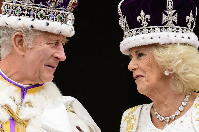 Britain's King Charles III and Queen Camilla look at each other as they stand on the balcony of the Buckingham Palace after their coronation, in London, Saturday, May 6, 2023. (Photo by Leon Neal/Pool Photo via AP Photo)