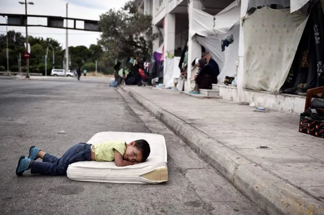 A refugee boy rests in a makeshift camp situated at the old Athens airport on June 13, 2016. (Photo by Louisa Gouliamaki/AFP Photo)