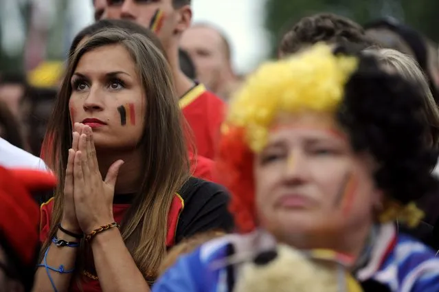 Belgian supporters react as they watch a broadcast of Belgium's 2014 World Cup quarter-final soccer match against Argentina in Brazil, on a screen at the King Baudouin Stadium in Brussels July 5, 2014. (Photo by Eric Vidal/Reuters)
