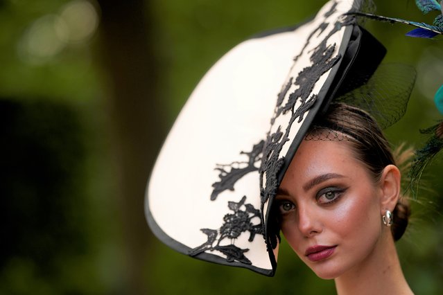 A racegoer arrives for Ladies Day of the Royal Ascot horse racing meeting, at Ascot Racecourse in Ascot, England, Thursday, June 22, 2023. (Photo by Alastair Grant/AP Photo)