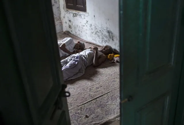 Hindu priests rest in their room after conducting morning prayers at Mukti Bhavan (Salvation House) in Varanasi, in the northern Indian state of Uttar Pradesh, June 17, 2014. (Photo by Danish Siddiqui/Reuters)