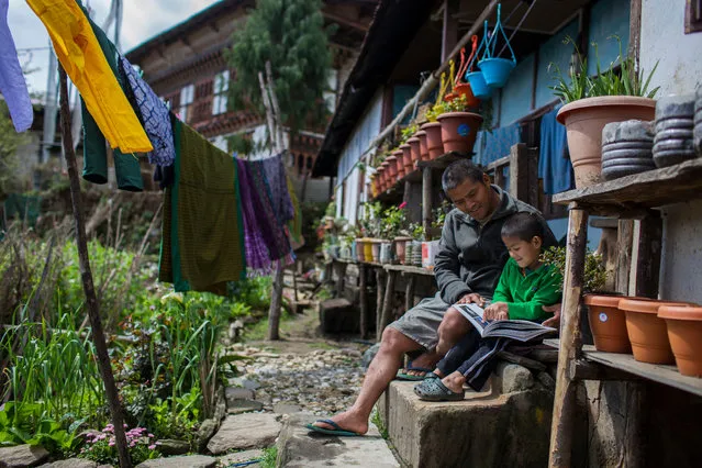 Dorji Duba, government ranger at Jigme Singye Wangchuck national park, at home with his son Yesel. (Photo by Emmanuel Rondeau/WWF UK/The Guardian)