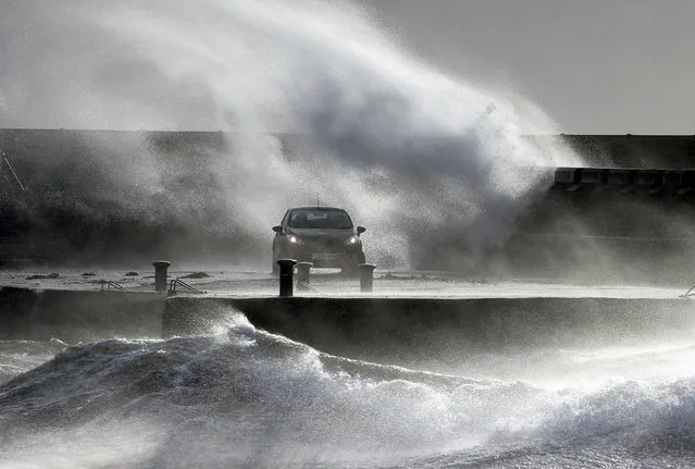 Waves lash the coast on the Ayrshire coast at Ardrossan, Scotland, Sunday, February 9, 2020. Trains, flights and ferries have been cancelled and weather warnings issued across the United Kingdom and in northern Europe as the storm with winds expected to reach hurricane levels batters the region. (Photo by Andrew Milligan/PA Wire via AP Photo)