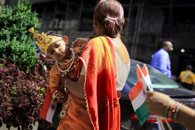 A child tries to watch people taking part in the 35th India day parade in New York August 16, 2015. (Photo by Eduardo Munoz/Reuters)