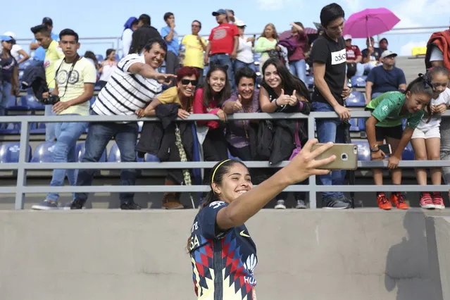 In this July 29, 2017 photo, America's forward Daniela Espinosa, takes a selfie with fans after the inaugural game of Mexico's first women's soccer league, against Xolos in Mexico City. America won the game 1-0. (Photo by Gustavo Martinez Contreras/AP Photo)