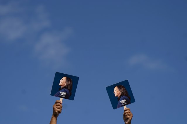 Supporters hold signs before Democratic presidential nominee Vice President Kamala Harris arrives to speak at a campaign rally, Wednesday, October 30, 2024, in Raleigh, N.C. (Photo by Allison Joyce/AP Photo)