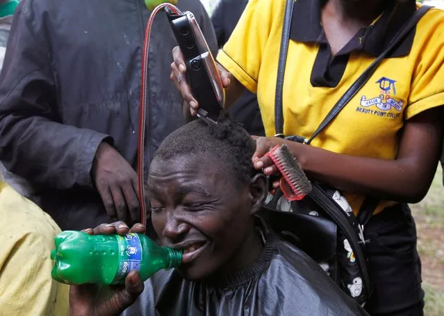 A teen gets a complementary shave at the Valentine's Day pageant dubbed “Valentine's Day Street Family Bash” as an empowerment and way to make people feel loved at the Jeevanjee Gardens in Nairobi, Kenya on February 14, 2020. (Photo by Njeri Mwangi/Reuters)