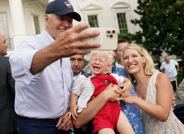 A child cries uncontrollably as U.S. President Joe Biden poses for a selfie while hosting the Congressional Picnic on the South Lawn of the White House in Washington, U.S., July 12, 2022. (Photo by Kevin Lamarque/Reuters)