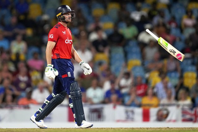 England's captain Jos Buttler throws his bat as he walks off the field, caught by West Indies' captain Rovman Powell for 83 runs, during the second T20 cricket match at Kensington Oval in Bridgetown, Barbados, Sunday, November 10, 2024. (Photo by Ricardo Mazalan/AP Photo)