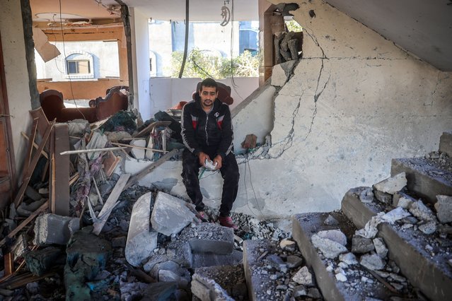 A man reacts as he sits in a heavily damaged building following an Israeli strike in Deir Al-Balah in the central Gaza Strip on November 15, 2024, amid the ongoing war between Israel and the Palestinian Hamas militant group. (Photo by Eyad Baba/AFP Photo)