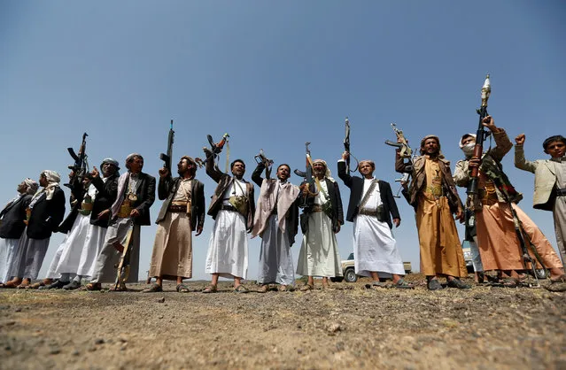 Tribesmen loyal to the Houthi movement hold up their rifles as they shout slogans during a pro-Houthi tribal gathering in a rural area near Sanaa, Yemen July 21, 2016. (Photo by Khaled Abdullah/Reuters)