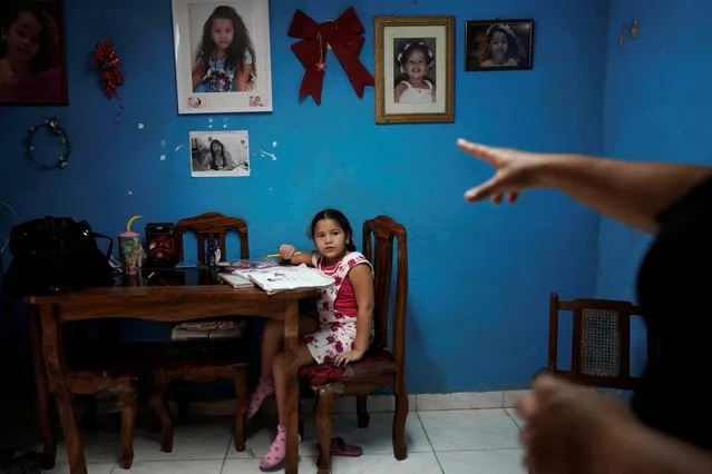 Liz Mariam, 6, receives instruction from her mother as she studies at home amid concerns about the spread of the coronavirus disease (COVID-19) outbreak, in Havana, Cuba, March 25, 2020. (Photo by Alexandre Meneghini/Reuters)