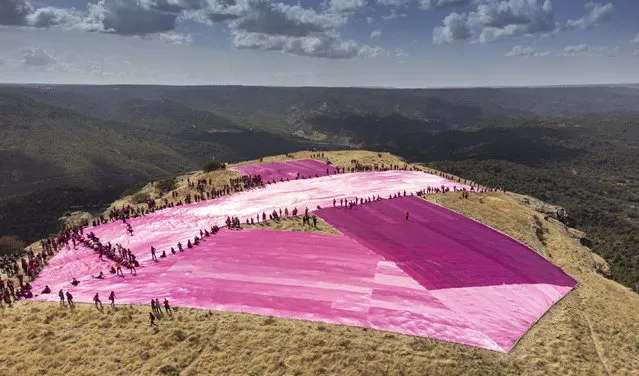 An aerial view taken from a drone of a pink ribbon of 25 meters by 275 meters placed by over 540 volunteers on the top of the twin mountain named “Tetasde Viana” (literally, “Viana's Tits”) in Trillo town, Guadalajara province, central Spain, 08 October 2022. This initiative against breast cancer has broken the Guinness Largest Awareness Ribbon record. (Photo by Nacho Izquierdo/EPA/EFE)