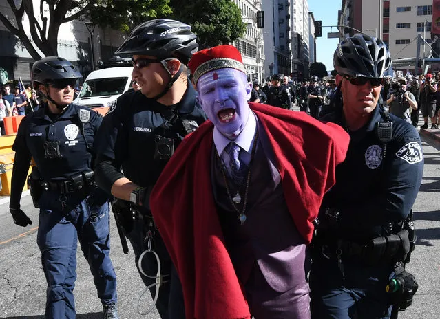A protester from the Refuse Fascism movement is arrested by police during a protest calling for the end of the administration of US President Donald Trump and Vice President Mike Pence in Los Angeles, California, November 4, 2017. (Photo by Mark Ralston/AFP Photo)