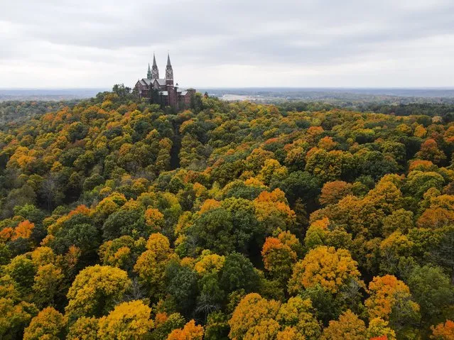 This image taken with a drone shows the trees around Holy Hill Basilica beginning to change colors Tuesday, October 11, 2022, in Hubertus, Wis. (Photo by Morry Gash/AP Photo)