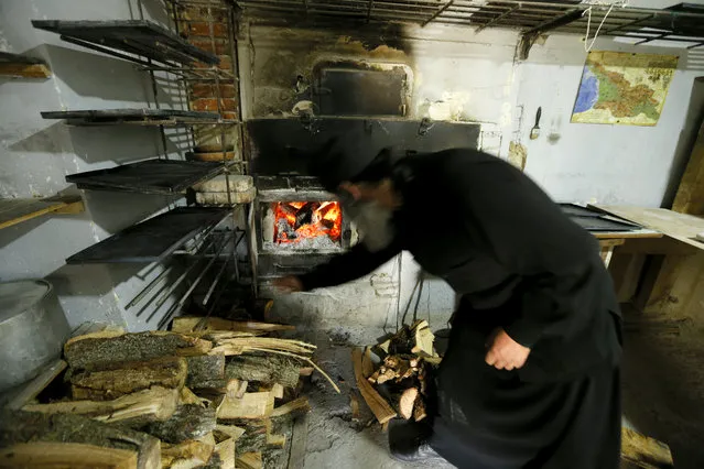 A man heats an oven, at the Martkopi Orthodox monastery, near the village of Martkopi same 30 kilometers from Tbilisi, Georgia, 19 April 2016. The monastery was founded by Father Anton Martkopeli in VI century. (Photo by Zurab Kurtsikidze/EPA)