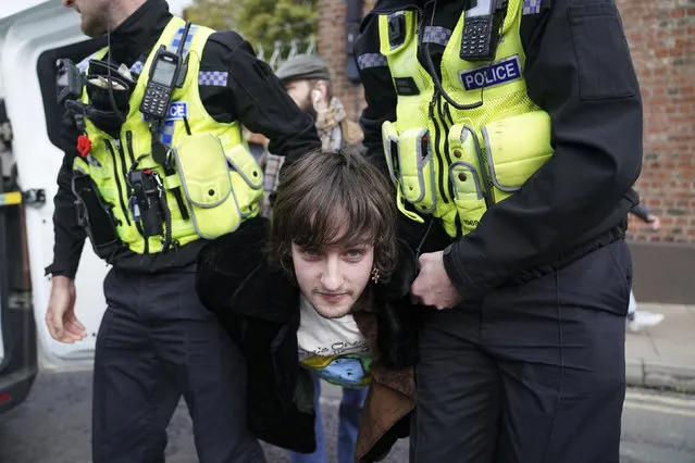 Police detain a protester after he appeared to throw eggs at King Charles III and the Queen Consort as they arrived for a ceremony at Micklegate Bar in York, where the Sovereign is traditionally welcomed to the city on Wednesday, November 9, 2022. (Photo by Jacob King/PA Images via Getty Images)