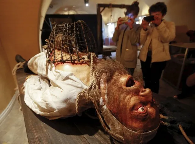 People visit the exhibition titled "Medieval Executions and Punishments" in Kiev, Ukraine, October 7, 2015. The popular scientific exhibition offers its visitors a historical journey into medieval times and unveils the topic of execution and punishment of that epoch, according to local media. (Photo by Valentyn Ogirenko/Reuters)