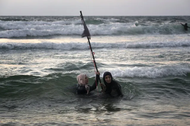 Palestinian women swim in the Mediterranean sea on the beach in Tel Aviv during the Eid al-Adha holiday on September 13, 2016. Thousands of Palestinians from the West Bank swam at beaches in and around the Israeli commercial capital Tel Aviv, after being granted permits to visit during the Eid al-Adha holiday. (Photo by Menahem Kahana/AFP Photo)