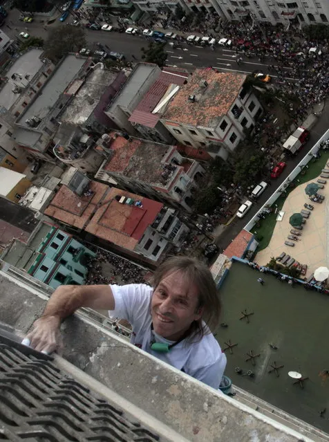 Alain Robert of France, who is known as "Spiderman", climbs the Habana Libre hotel in Havana February 4, 2013. Robert, who scales buildings all over the world without safety equipment, successfully climbed the hotel which is 126 metres (413 feet) high.  REUTERS/Stringer (CUBA - Tags: SOCIETY)