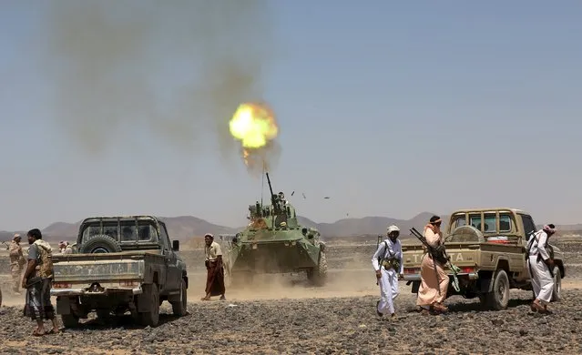 Fighters of the Popular Resistance Committees fire from an armoured vehicle during a ceremony where they formally take over territory that the government had managed to recover from Houthi militants, in the central province of Marib October 11, 2015. (Photo by Reuters/Stringer)