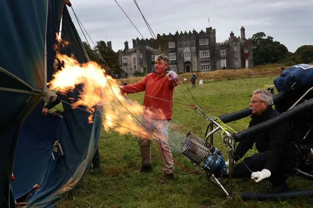 Hot air balloon pilots Joe Leahy, left and Tom McCormack in preperation before flying from Birr Castle during the 50th Irish Hot Air Ballooning Championships on September 25, 2022. The Irish championships are the longest running balloning championships in the world. (Photo by Brenda Fitzsimons/The Irish Times)