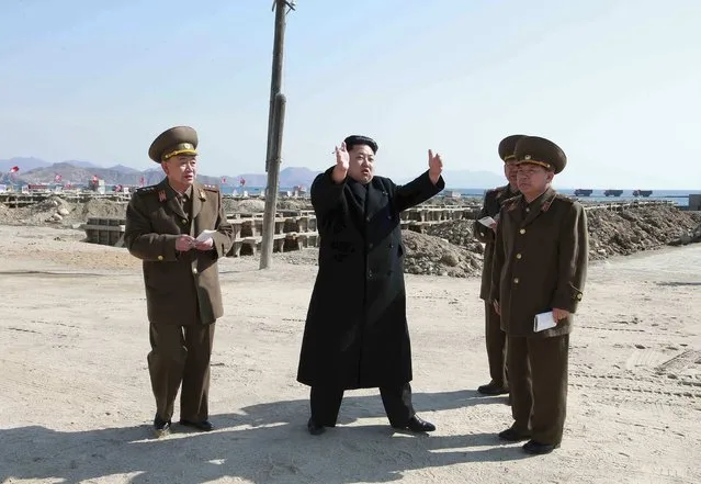 North Korean leader Kim Jong Un (2nd L) gives field guidance to the construction site of the May 27 Fishery Station in this undated photo released by North Korea's Korean Central News Agency (KCNA) in Pyongyang March 14, 2015. (Photo by Reuters/KCNA)
