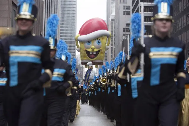 The Spongebob Squarepants balloon floats down Sixth Avenue during the 88th Annual Macy's Thanksgiving Day Parade in New York November 27, 2014. (Photo by Andrew Kelly/Reuters)