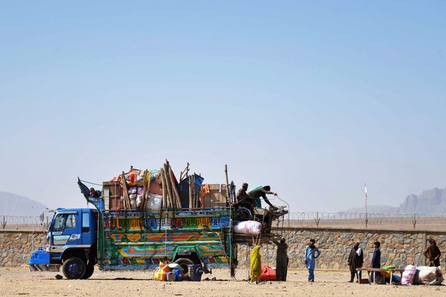 Afghan refugees unload their belongings from a truck upon their arrival from Pakistan, in Takhta Pul district of Kandahar Province on May 7, 2025. (Photo by Sanaullah Seiam/AFP Photo)