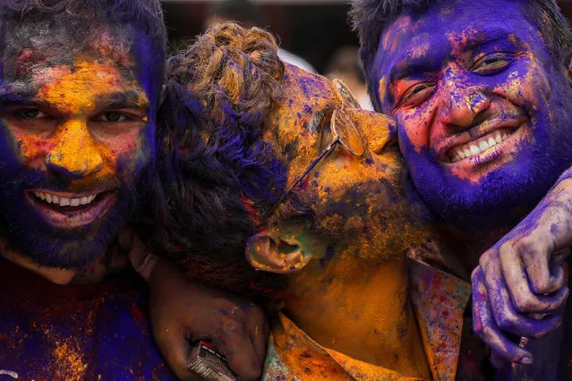 Revelers with color powder-stained faces attend a Holi festival celebration in Mumbai, India, 07 March 2023. Holi, also known as the Festival of Colors, is an ancient Hindu festival symbolizing the victory of good over evil and marking the arrival of spring. It is observed with joyful gatherings during which revelers cover each other in colored powders. (Photo by Divyakant Solanki//EPA/EFE)