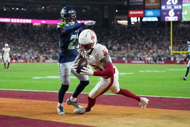 Arizona Cardinals wide receiver Marvin Harrison Jr., right, catches a touchdown pass as Seattle Seahawks cornerback Devon Witherspoon defends during the second half of an NFL football game Thursday, September 25, 2025, in Glendale, Ariz. (Photo by Rick Scuteri/AP Photo)