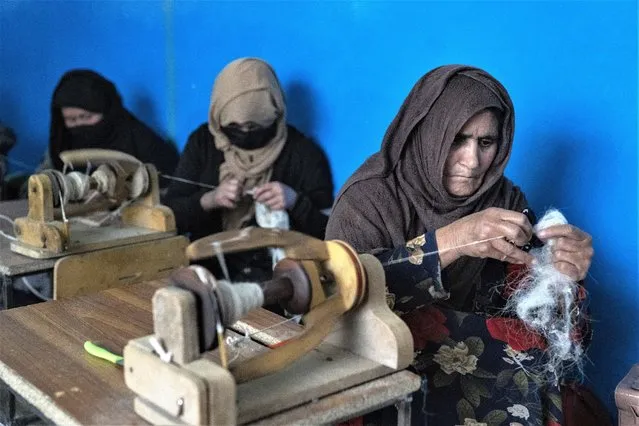 Afghan women weave wools for making carpets at a traditional carpet factory in Kabul, Afghanistan, Monday, March 6, 2023. After the Taliban came to power in Afghanistan, women have been deprived of many of their basic rights. (Photo by Ebrahim Noroozi/AP Photo)
