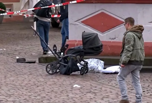 This image grab taken from a video obtained from Steil-TV shows a cordoned off area with a destroyed pram at one of the scenes where a car drove into pedestrians the center of Trier, southwestern Germany, on December 1, 2020. At least two people were killed and several injured when a car drove into a pedestrian zone in the southwestern German city of Trier on December 1, 2020, police said, adding that the driver had been arrested. (Photo by Steil-TV/AFP Photo)