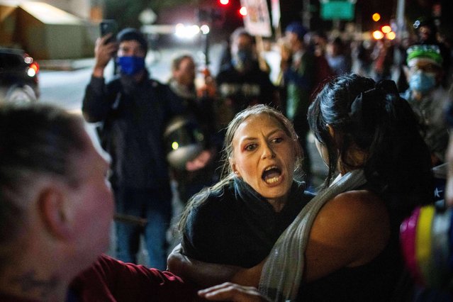 A protester yells at police and federal officers during a protest at a U.S. Immigration and Customs Enforcement facility in Portland, Ore. on Sunday, October 5, 2025. (Photo by Ethan Swope/AP Photo)