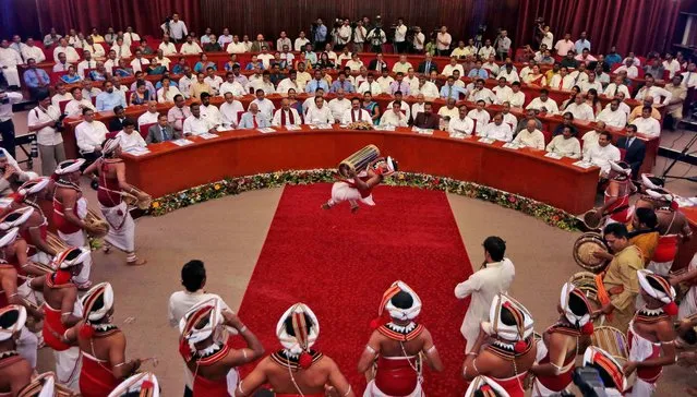 Sri Lankan President Mahinda Rajapaksa, center in front row, watches traditional dancers perform during the launch of his election manifesto in Colombo, Sri Lanka, Tuesday, December 23, 2014. Rajapaksa will face his former health minister Maithripala Sirisena in the January 8 presidential elections. (Photo by Eranga Jayawardena/AP Photo)