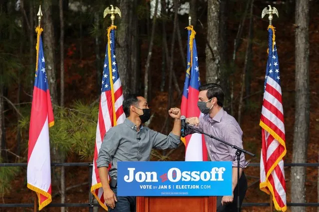 Democratic U.S. Senate candidate Jon Ossoff bumps elbows with former U.S. Housing and Urban Development Secretary Julian Castro during a Latino voter registration event in Lilburn, Georgia, U.S. December 7, 2020. (Photo by Dustin Chambers/Reuters)