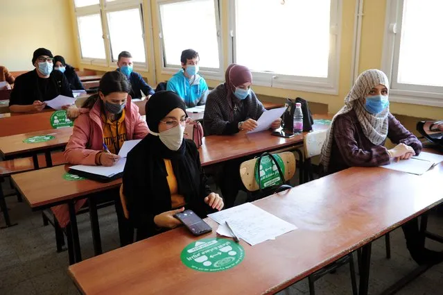 Students wearing face masks and obeying social distance rule are seen at a classroom at Algiers University in Algiers, Algeria on December 15, 2020. Algeria on Tuesday announced reopening of universities for the new academic year, after a nine-month hiatus due to coronavirus, (Photo by Mousaab Rouibi/Anadolu Agency via Getty Images)