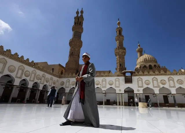 A young sheikh wearing full official Al Azhar clothing walks during an event of the Al-Azhar Mosque on the 1083th Hijri anniversary for the establishment during the holy month of Ramadan in the old Islamic area of Cairo, Egypt on March 29, 2023. (Photo by Amr Abdallah Dalsh/Reuters)