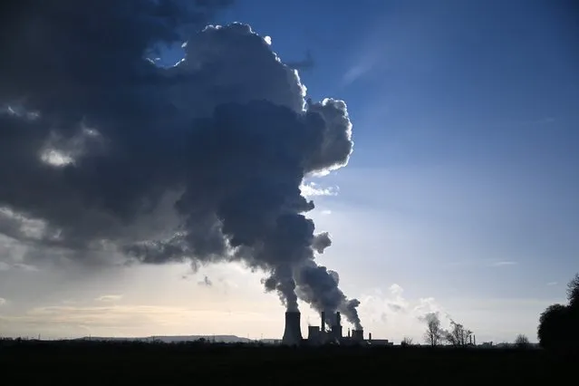 Huge clouds of steam come out of the chimneys of coal power plant in Niederaussem, western Germany, on January 17, 2023. (Photo by Ina Fassbender/AFP Photo)