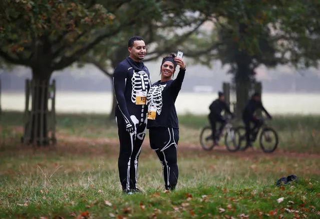 Participants pose for a selfie before the start of a Trick or Treat halloween fun run in Richmond Park, London, Britain October 30, 2016. (Photo by Peter Nicholls/Reuters)