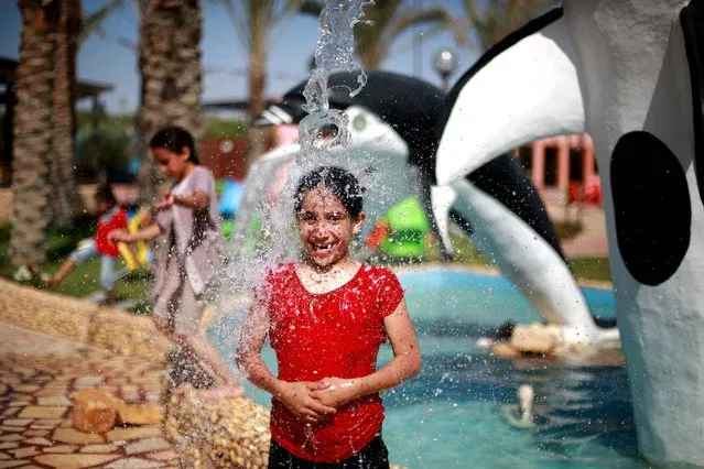A Palestinian girl plays in the summer camp that is installed in the public park in Gaza, on June 12, 2013. (Photo by Mohammed Abed/AFP Photo)
