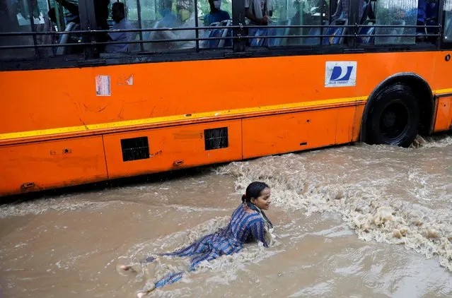 A girl plays on a flooded street after heavy rains in New Delhi, India, July 21, 2020. (Photo by /Reuters)