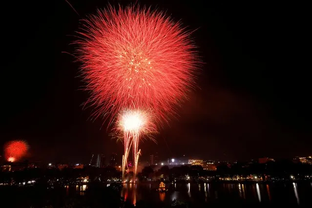 Fireworks explode over Turtle Tower on Hoan Kiem Lake during New Year's Eve celebrations in Hanoi, Vietnam on January 1, 2021. (Photo by Kham via Reuters)