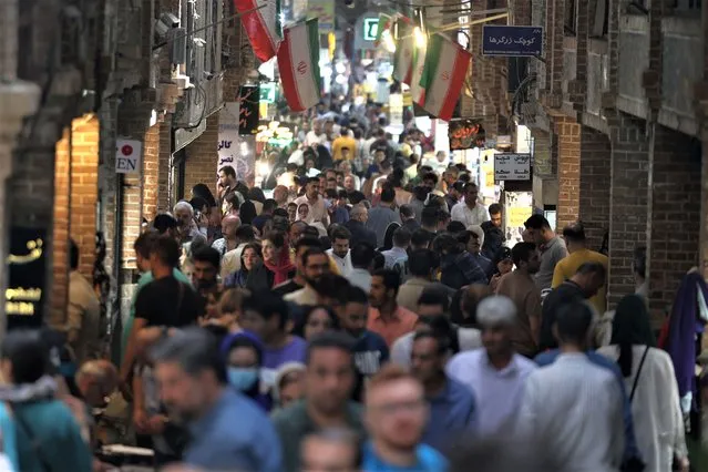 Iranians shop at the Grand Bazaar in Tehran on May 22, 2023. (Photo by Atta Kenare/AFP) Photo