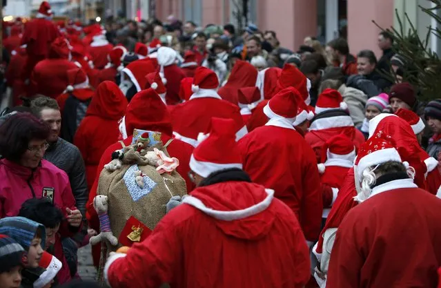 People dressed as Santa Claus take part in the 22nd Santa Claus meeting in Auerbach, Germany, December 6, 2015. (Photo by Michaela Rehle/Reuters)