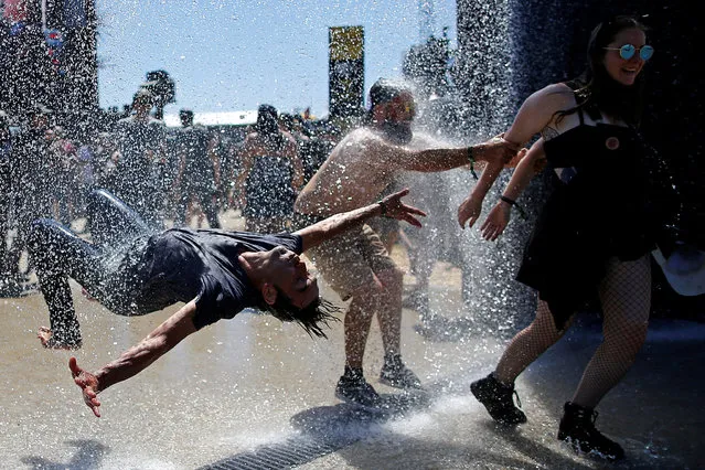 Festival-goers cool off as they attend the Hellfest music Festival in Clisson, France, June 22, 2018. (Photo by Stephane Mahe/Reuters)