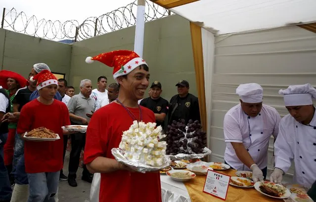 Inmates carry dishes that they prepared during a Christmas event at Sarita Colonia male prison in Callao, Peru, December 18, 2015. (Photo by Mariana Bazo/Reuters)